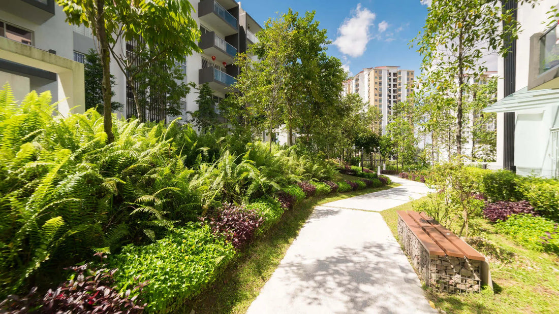 Wooden bench on stone base along paved path in lush urban garden oasis
