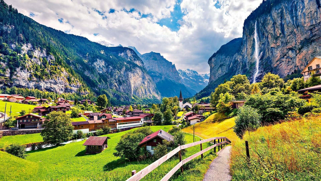 Captivating landscape of village in lush valley with waterfall