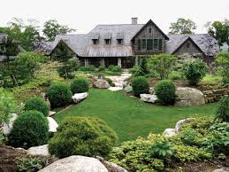 Rustic Tennessee house with dark gray shingles amid evergreens