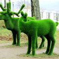Vibrant green grass-covered deer sculptures in Topiary Moss outdoors